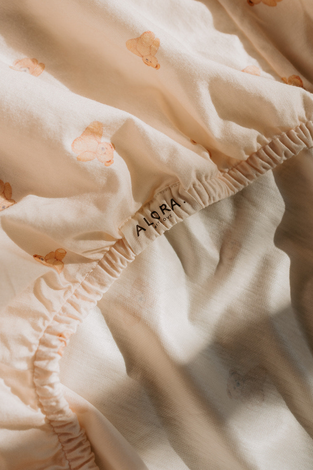 Close-up of the Tiny Teddy print on an Alora with Love waterproof fitted sheet